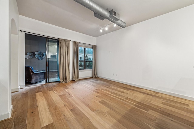 1901 Post Oak Blvd Unit 1206, Houston, TX 77056 - empty room with light wood-type flooring and arched walkways