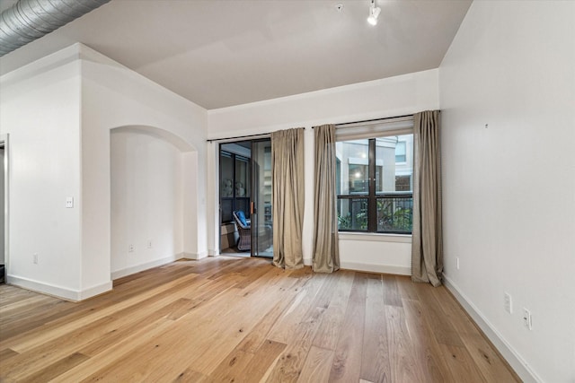 1901 Post Oak Blvd Unit 1206, Houston, TX 77056 - unfurnished room with light wood finished floors and baseboards