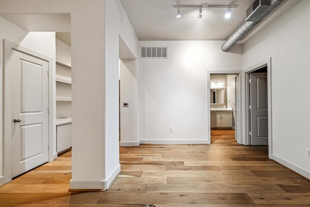 1901 Post Oak Blvd Unit 1206, Houston, TX 77056 - unfurnished bedroom featuring wood finished floors and connected bathroom