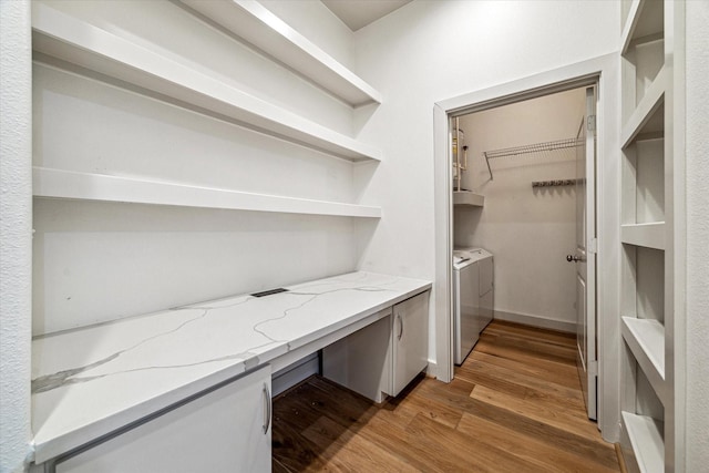 1901 Post Oak Blvd Unit 1206, Houston, TX 77056 - laundry room with light wood finished floors, washer and dryer, and an office area