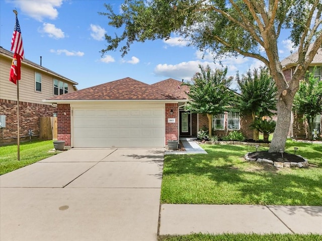 1803 Winding Trail Ln, Alvin, TX 77511 - view of front of house with brick siding, driveway, a garage, and a front lawn