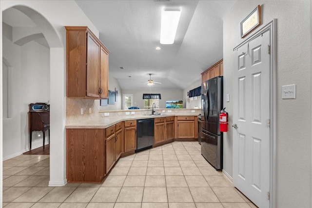 1803 Winding Trail Ln, Alvin, TX 77511 - kitchen featuring dishwashing machine, freestanding refrigerator, light tile patterned flooring, brown cabinetry, and light countertops