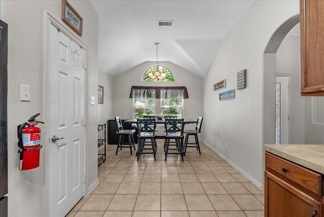 1803 Winding Trail Ln, Alvin, TX 77511 - dining room featuring arched walkways, vaulted ceiling, and light tile patterned floors
