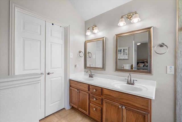 1803 Winding Trail Ln, Alvin, TX 77511 - full bath featuring double vanity, tile patterned flooring, vaulted ceiling, and ensuite bath