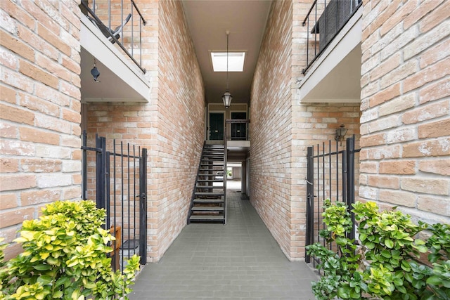 2230 S Piney Point Rd Unit 206, Houston, TX 77063 - doorway to property featuring brick siding and a gate