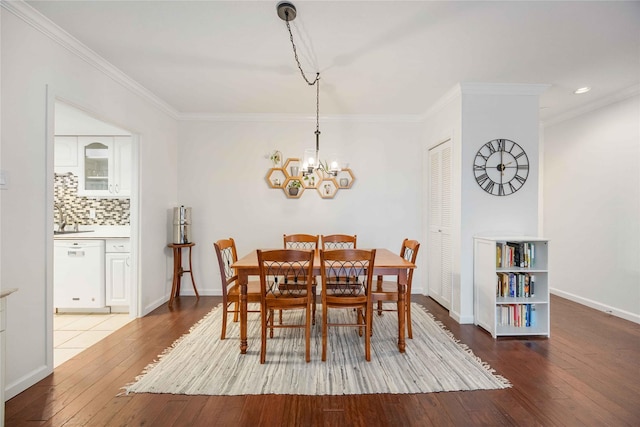 2230 S Piney Point Rd Unit 206, Houston, TX 77063 - dining space with wood-type flooring, crown molding, and a chandelier