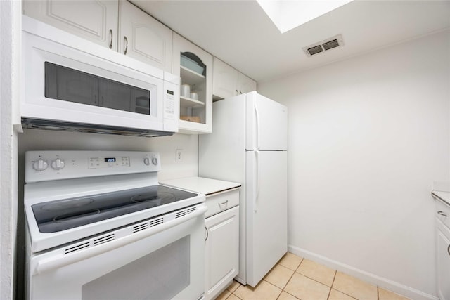 2230 S Piney Point Rd Unit 206, Houston, TX 77063 - kitchen featuring white appliances, white cabinets, light countertops, and light tile patterned floors