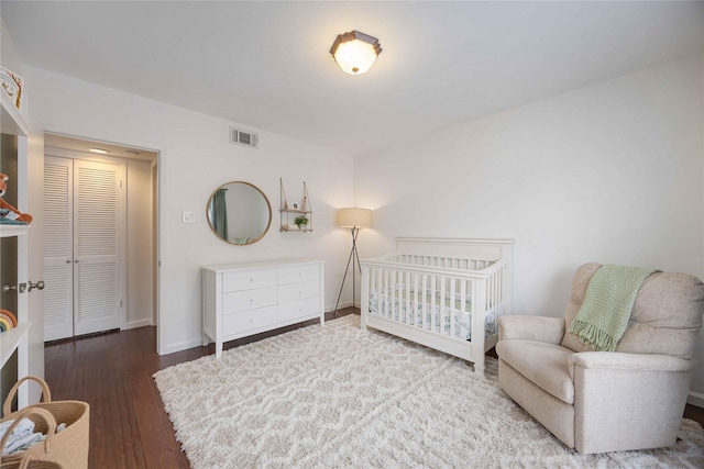 2230 S Piney Point Rd Unit 206, Houston, TX 77063 - bedroom with wood finished floors and a crib