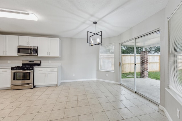 21619 Knightsbrook Ln, Katy, TX 77449 - kitchen featuring stainless steel appliances, white cabinets, light countertops, hanging light fixtures, and a chandelier