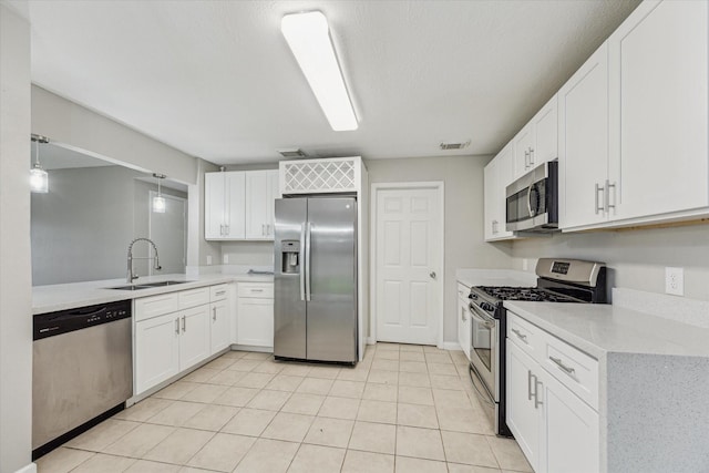 21619 Knightsbrook Ln, Katy, TX 77449 - kitchen with stainless steel appliances, white cabinets, and light tile patterned flooring