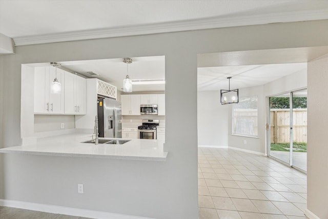 21619 Knightsbrook Ln, Katy, TX 77449 - kitchen with stainless steel appliances, light countertops, white cabinets, light tile patterned floors, and crown molding