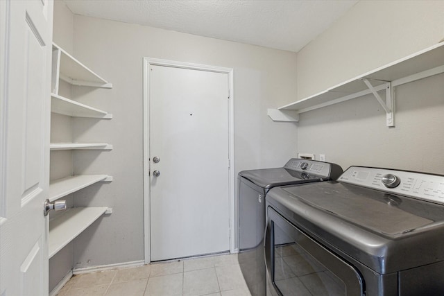 21619 Knightsbrook Ln, Katy, TX 77449 - laundry area with washing machine and clothes dryer and light tile patterned floors