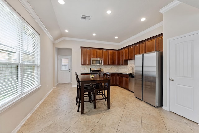 20726 Ranch Mill Ln, Cypress, TX 77433 - kitchen featuring appliances with stainless steel finishes, tasteful backsplash, light tile patterned floors, crown molding, and recessed lighting