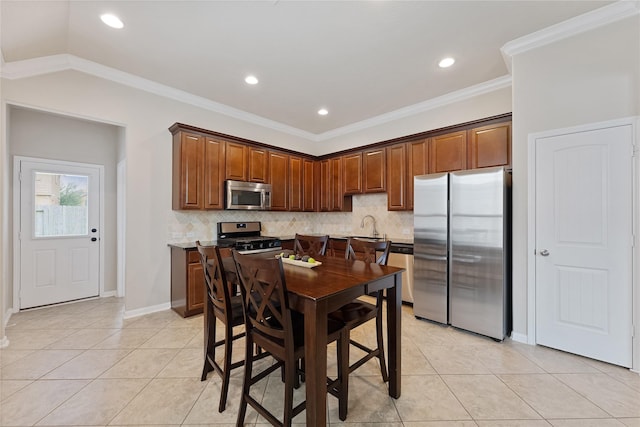 20726 Ranch Mill Ln, Cypress, TX 77433 - kitchen with appliances with stainless steel finishes, light tile patterned floors, backsplash, recessed lighting, and crown molding