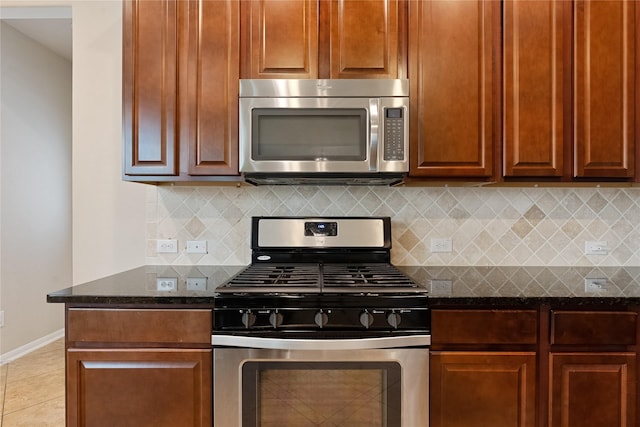 20726 Ranch Mill Ln, Cypress, TX 77433 - kitchen featuring stainless steel appliances, tasteful backsplash, dark stone countertops, and light tile patterned floors