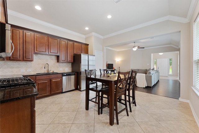 20726 Ranch Mill Ln, Cypress, TX 77433 - kitchen with appliances with stainless steel finishes, light tile patterned floors, decorative backsplash, a ceiling fan, and recessed lighting