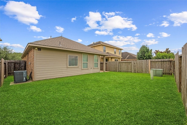 20726 Ranch Mill Ln, Cypress, TX 77433 - rear view of house featuring a fenced backyard, brick siding, and roof with shingles