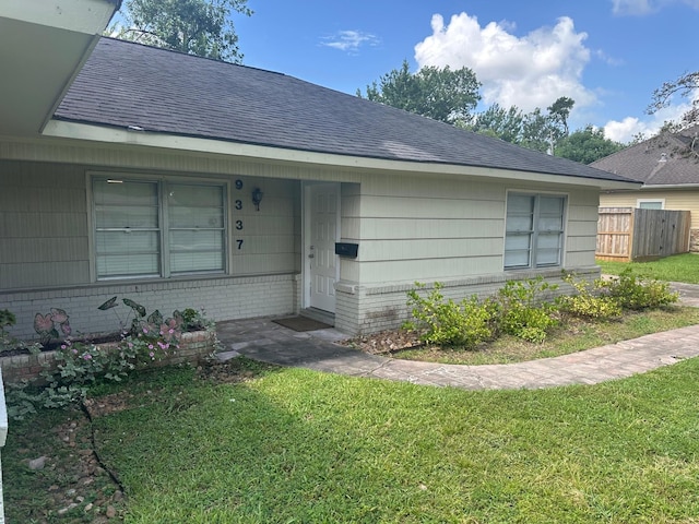 9337 Walterville Rd, Houston, TX 77080 - view of front facade with a shingled roof and brick siding