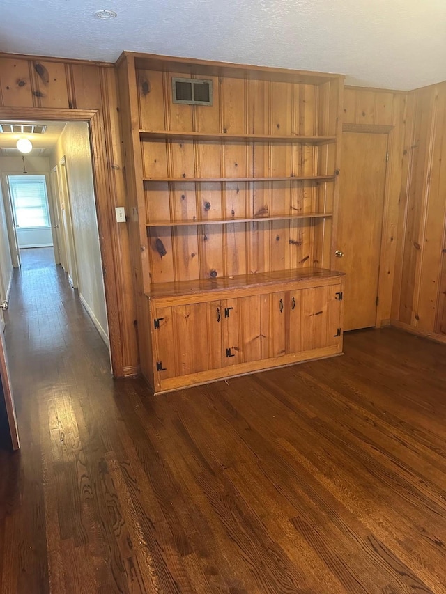 9337 Walterville Rd, Houston, TX 77080 - spare room with dark wood-style floors and wood walls