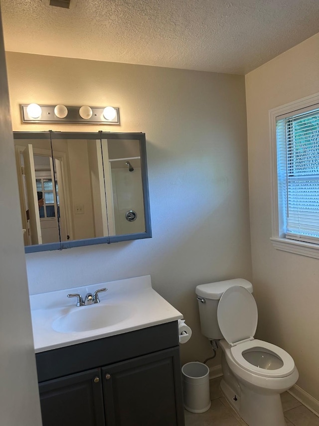 9337 Walterville Rd, Houston, TX 77080 - bathroom with vanity, a textured ceiling, tile patterned flooring, and a shower
