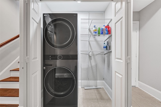 1320 Studer St, Houston, TX 77007 - washroom with stacked washer / drying machine and light tile patterned floors