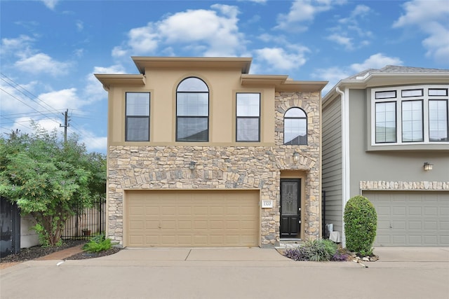 1320 Studer St, Houston, TX 77007 - view of front of house featuring stone siding, a garage, concrete driveway, and stucco siding