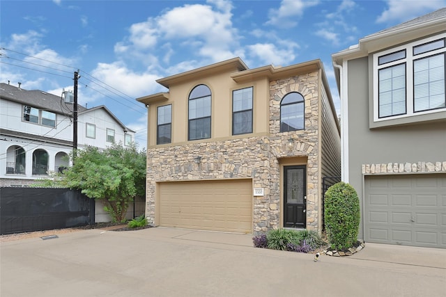 1320 Studer St, Houston, TX 77007 - view of front of property with stone siding, concrete driveway, a garage, and stucco siding