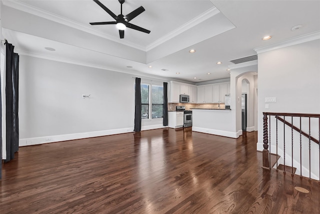 1320 Studer St, Houston, TX 77007 - unfurnished living room with arched walkways, a ceiling fan, dark wood finished floors, recessed lighting, and ornamental molding