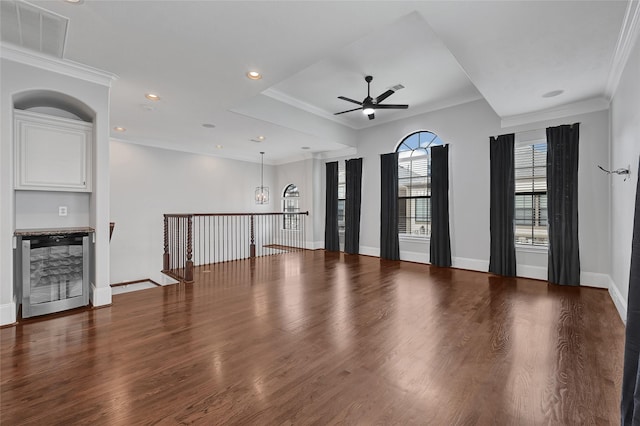 1320 Studer St, Houston, TX 77007 - unfurnished living room featuring wine cooler, ceiling fan, wood finished floors, a chandelier, and crown molding