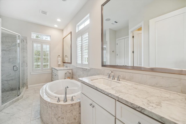1126 Lake Pointe Pkwy, Sugar Land, TX 77478 - bathroom featuring two vanities, a jetted tub, a shower stall, marble finish floors, and recessed lighting