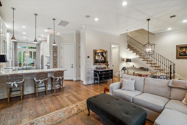 1126 Lake Pointe Pkwy, Sugar Land, TX 77478 - living room featuring stairs, crown molding, wood finished floors, and recessed lighting