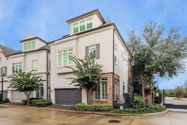 1126 Lake Pointe Pkwy, Sugar Land, TX 77478 - view of front of property with stucco siding, concrete driveway, a gate, and a garage