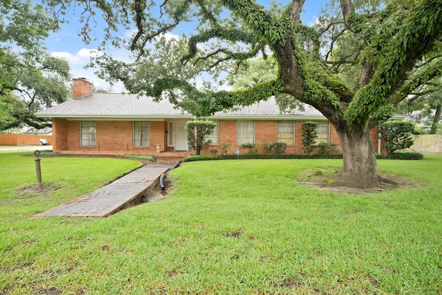 303 S Jackson St, Alvin, TX 77511 - ranch-style house with a chimney and brick siding