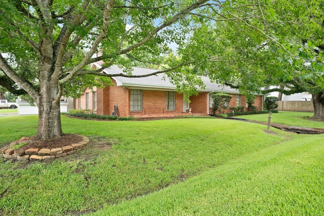303 S Jackson St, Alvin, TX 77511 - single story home with brick siding, a front yard, and a shingled roof