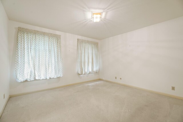 303 S Jackson St, Alvin, TX 77511 - carpeted empty room featuring baseboards