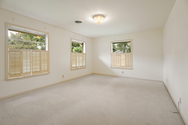 303 S Jackson St, Alvin, TX 77511 - unfurnished room with healthy amount of natural light and carpet floors