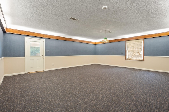 303 S Jackson St, Alvin, TX 77511 - below grade area featuring carpet flooring and a textured ceiling