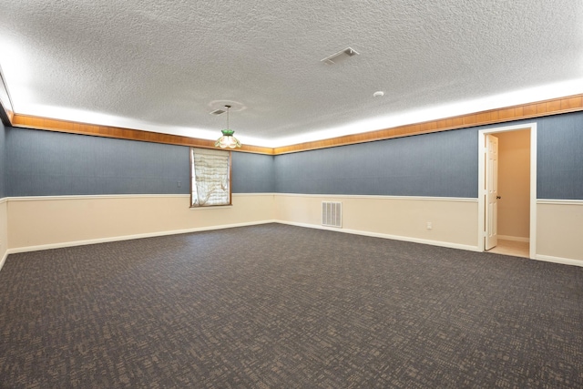 303 S Jackson St, Alvin, TX 77511 - carpeted empty room with a textured ceiling and baseboards