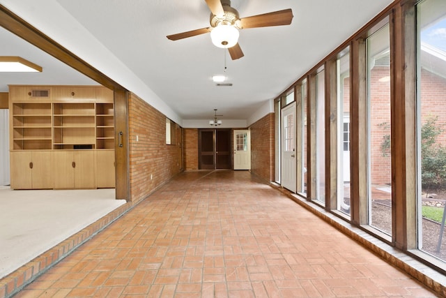 303 S Jackson St, Alvin, TX 77511 - hallway with brick flooring and brick wall
