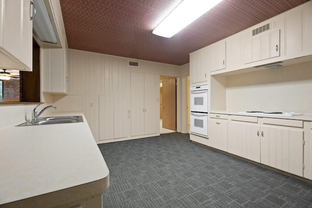 303 S Jackson St, Alvin, TX 77511 - kitchen featuring white appliances, light countertops, and white cabinetry
