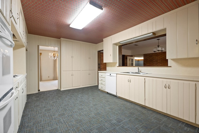 303 S Jackson St, Alvin, TX 77511 - kitchen with white appliances, a chandelier, light countertops, dark colored carpet, and white cabinets