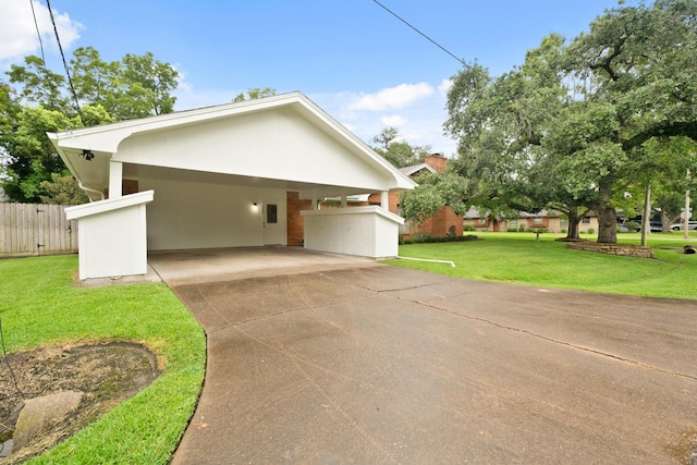 303 S Jackson St, Alvin, TX 77511 - view of side of home featuring concrete driveway and a carport