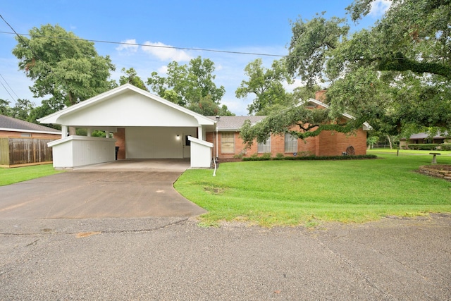 303 S Jackson St, Alvin, TX 77511 - view of front facade featuring concrete driveway, an attached carport, and brick siding
