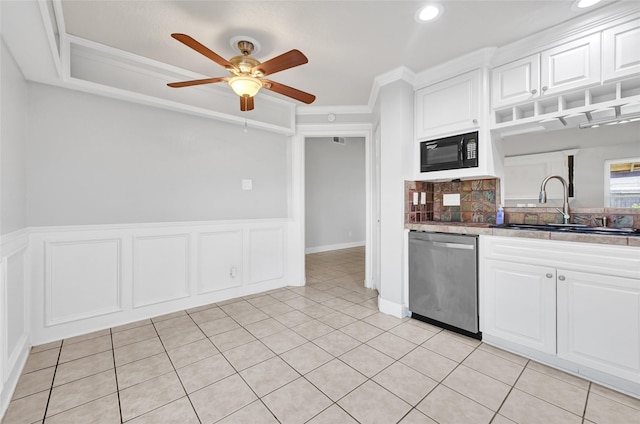 20042 S Pecos Valley Trl, Katy, TX 77449 - kitchen with stainless steel dishwasher, black microwave, a ceiling fan, ornamental molding, and white cabinetry