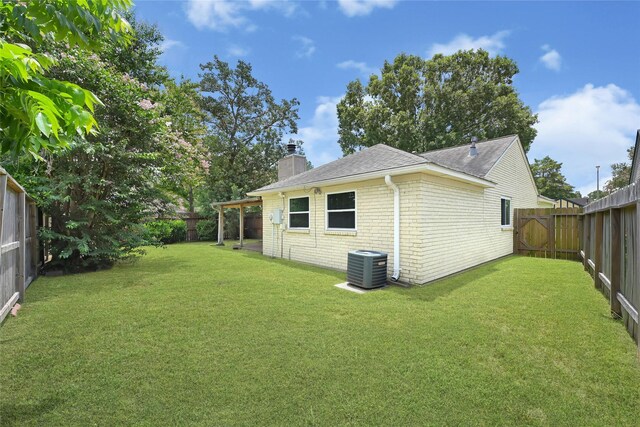 20042 S Pecos Valley Trl, Katy, TX 77449 - view of side of home featuring a chimney, a fenced backyard, brick siding, and roof with shingles