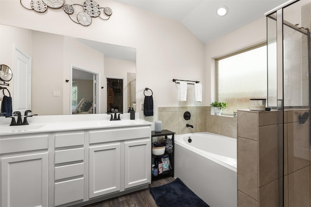 3051 Newcastle Crest Ln, Dickinson, TX 77539 - bathroom with a garden tub, a shower stall, double vanity, wood finished floors, and vaulted ceiling