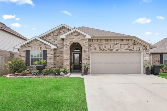 3051 Newcastle Crest Ln, Dickinson, TX 77539 - french country style house featuring a garage, brick siding, driveway, and roof with shingles
