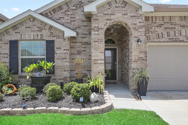 3051 Newcastle Crest Ln, Dickinson, TX 77539 - property entrance with a garage, brick siding, and driveway