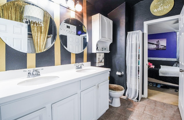 4723 Peninsula Garden Way, Humble, TX 77396 - full bathroom featuring ensuite bath, double vanity, and a textured wall