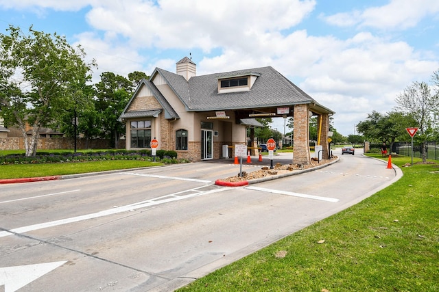 4723 Peninsula Garden Way, Humble, TX 77396 - view of street featuring traffic signs, curbs, and a gated entry